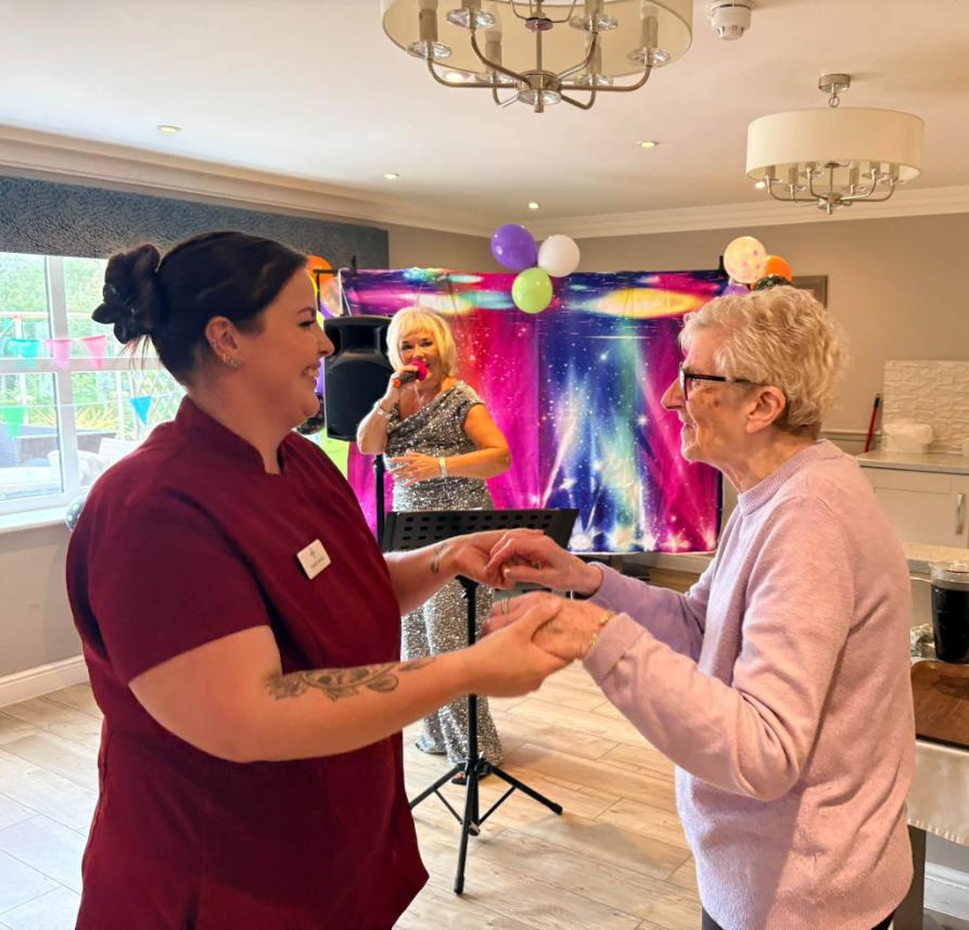older lady and carer dancing