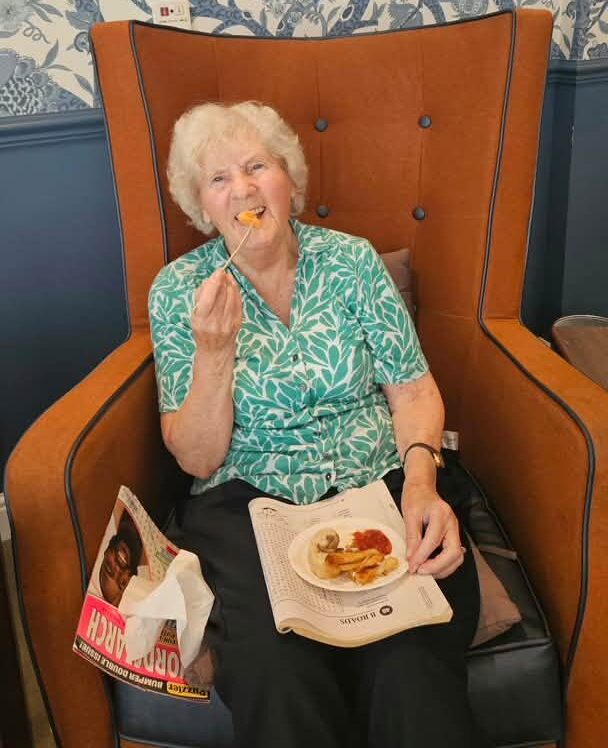 resident smiling with buffet food