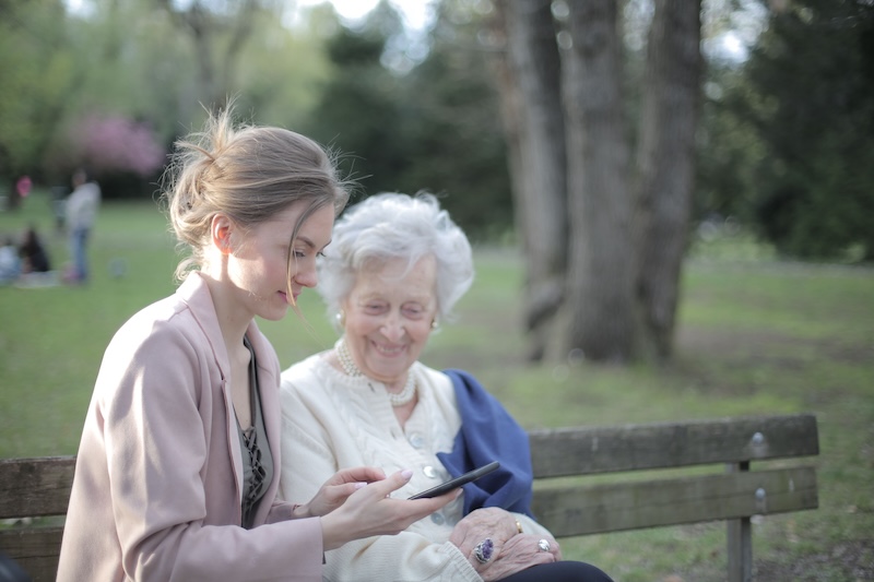 resident and woman on bench